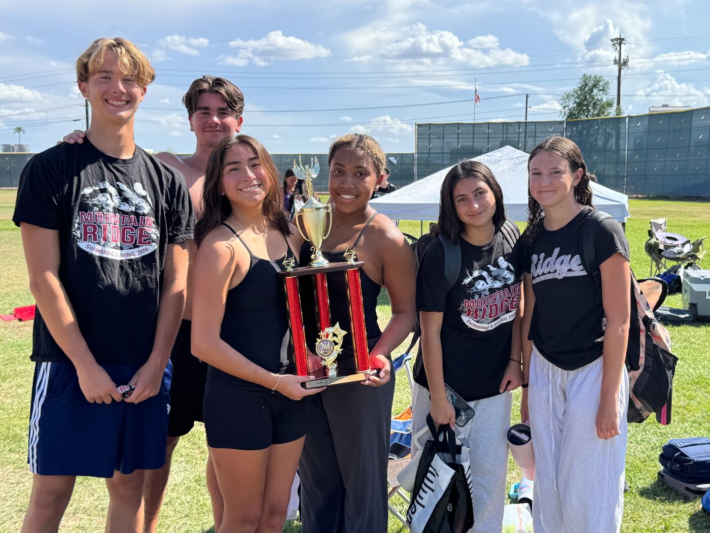 Mountain Ridge Swim and Dive team members holding a trophy